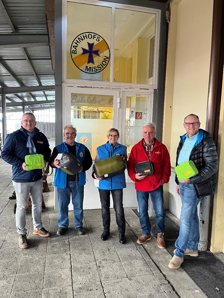 fünf Personen bei der Übergabe von Schlafsäcken vor der Bahnhofsmission in Schweinfurt